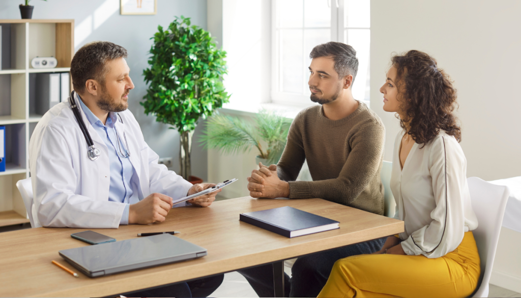 Ein Paar das beim Arzt sitzt